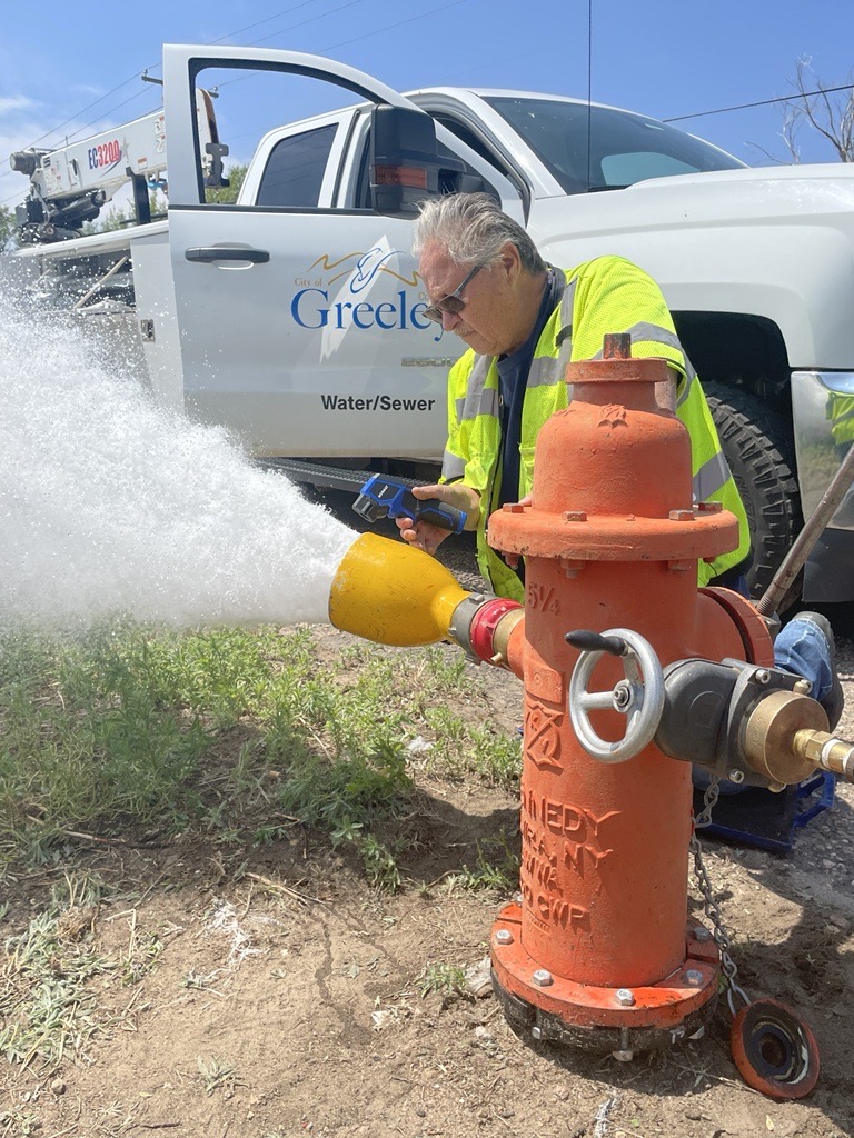 Photo of a Certified Water Distribution System Operator Flushing a Water Hydrant