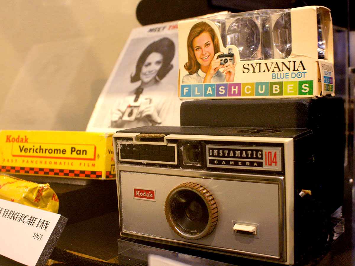 Collection of historic technology and devices used in photography, such as a Kodak Instamatic camera, Verichrome Pan film, and Syvania Flash Cubes