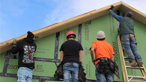 Workers contributing to housing development as part of Habitat for Humanity project.