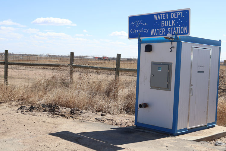 A rural setup featuring Greeley's Bulk Water Station used for accessing large quantities of water.