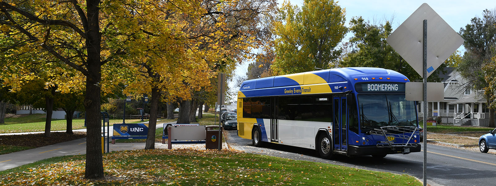 A GET bus with its destination set to Boomerag at a UNC bus stop in the fall