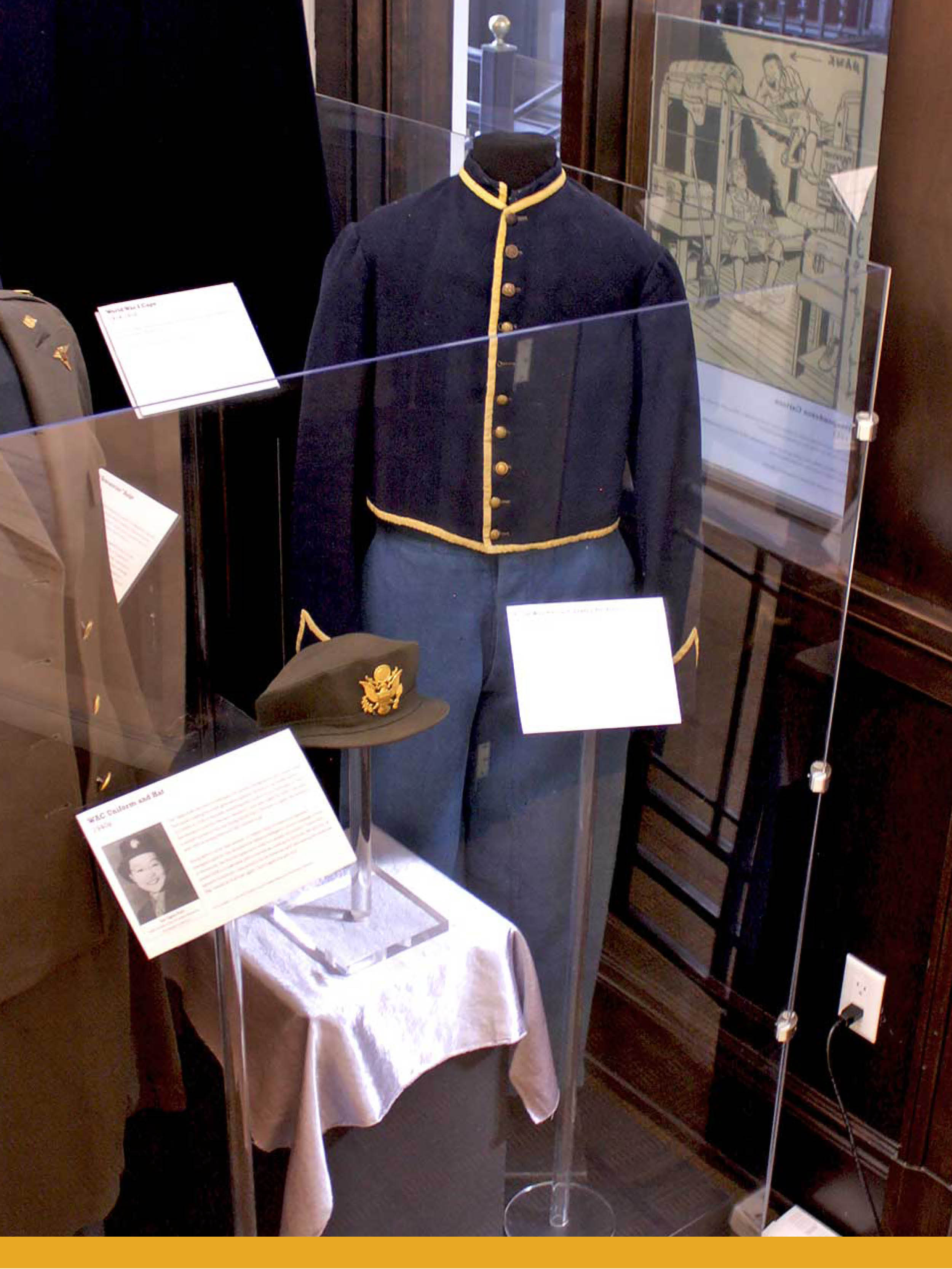 A mannequin wearing a dark blue, wool, button-up jacket, and lighter blue wool pants