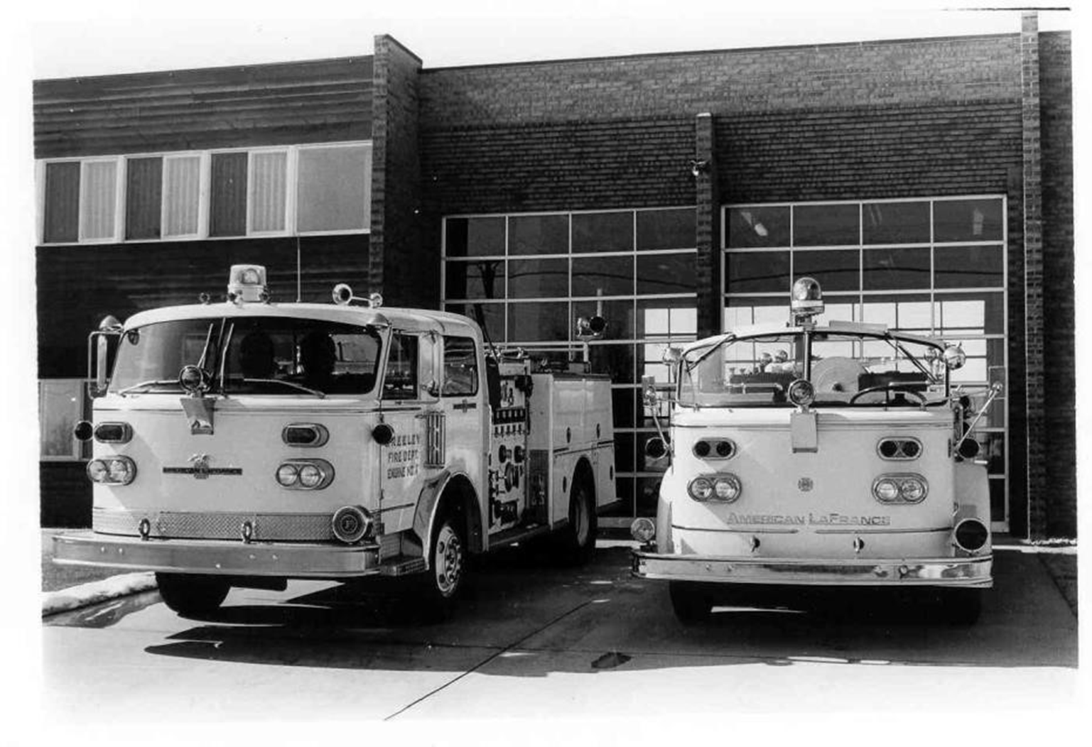 A 1982 photograph showcasing two firefighting vehicles parked in front of Greeley's Fire Station #4.