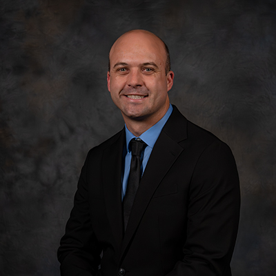 Professional portrait of Craig Huddleston in a suit and tie