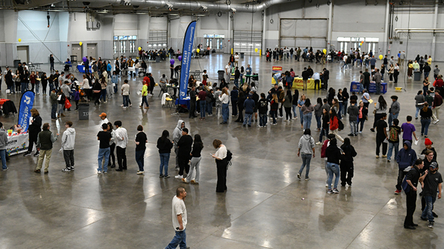 Job seekers visit booths at the Young Adult Job Fair at Island Grove Event Center