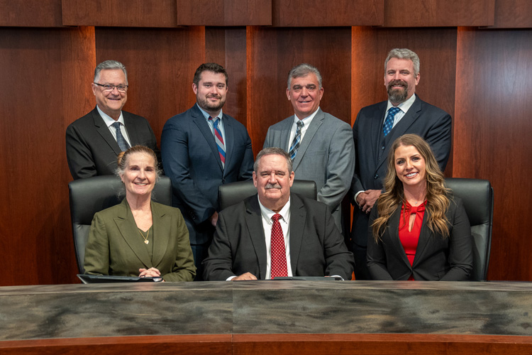 A professional photo of city council members seated and standing in a formal setting, November 2023.
