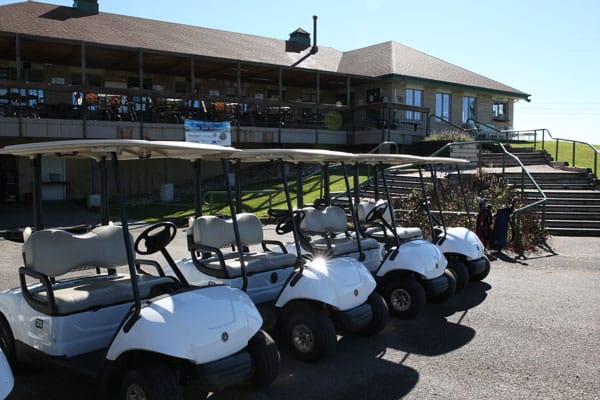 Image showcasing several golf carts parked in front of a facility, highlighting recreational activities and amenities provided for residents and visitors.