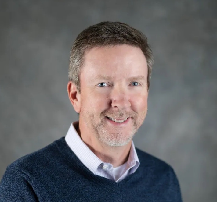 This is a photo of Brian McBroom wearing a sweater