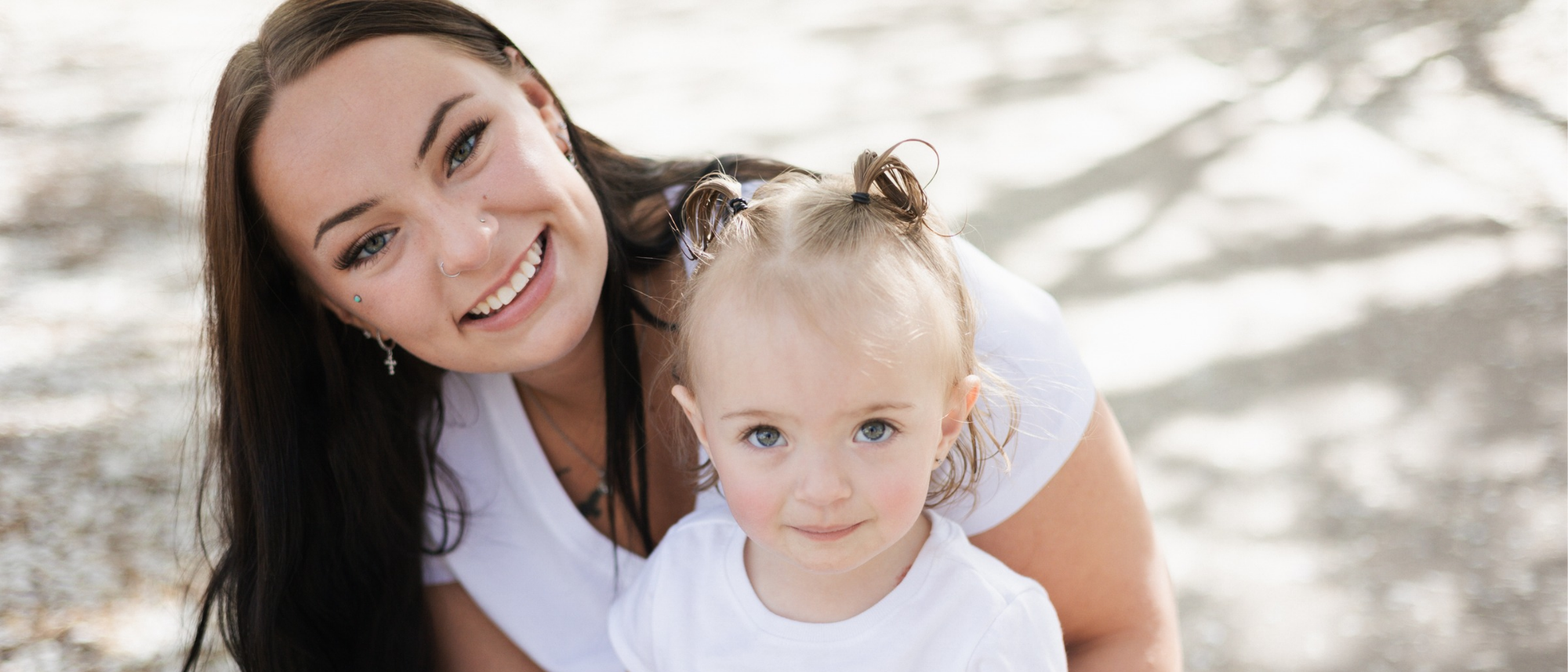 Hope House Northern Colorado teen mom and daughter sitting together and smiling. 