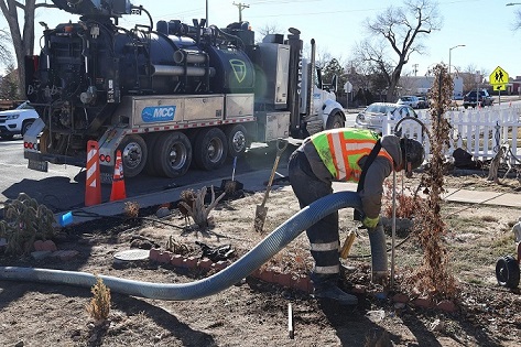 A Greeley Water and Sewer worker performs an inspection for lead service lines in a residential area.