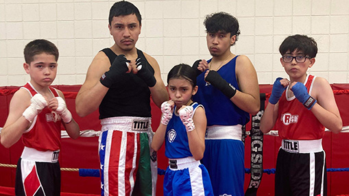 A group of young athletes showcasing teamwork and sportsmanship at the Rodarte Boxing Club.