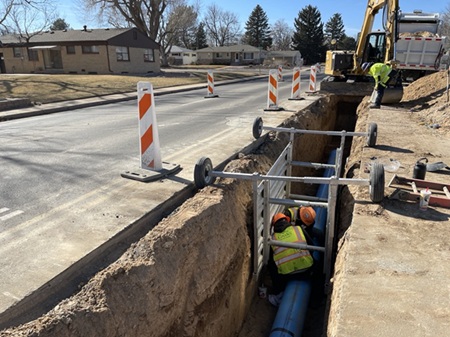 Photo of workers in a ditch and shoring box. 