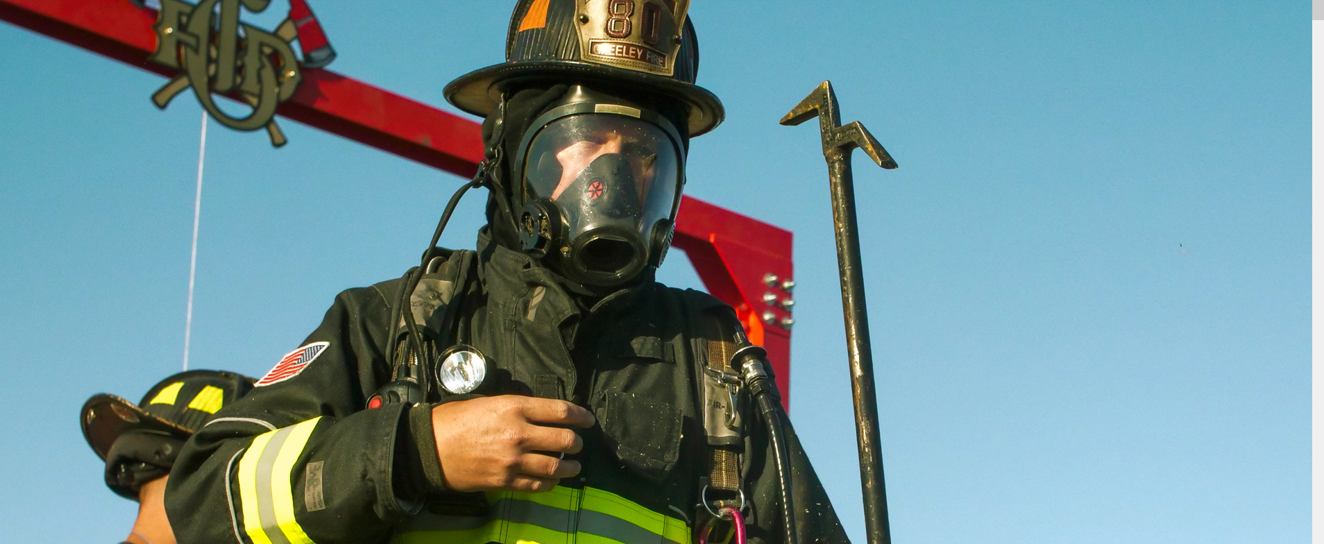 A Greeley firefighter wearing full gear prepares for intense training exercises.
