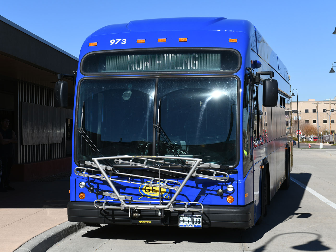 Exterior of a bus with Now Hiring on the digital destination display