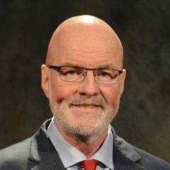 Official portrait of Greeley Council Member Ed Clark in formal attire.