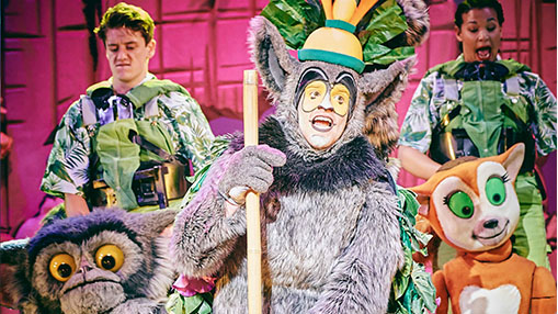 A lively depiction of Madagascar characters featuring colorful costumes and energetic performers.