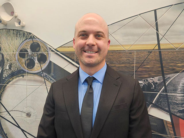 Councilman Select Craig Huddleston stands in front of an artistic background near Council Chambers