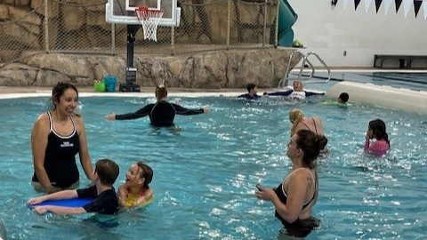 Instructors work with students in swim lessons at the Family FunPlex