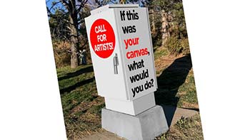 A utility box wrapped with text inviting local artists to envision its transformation.