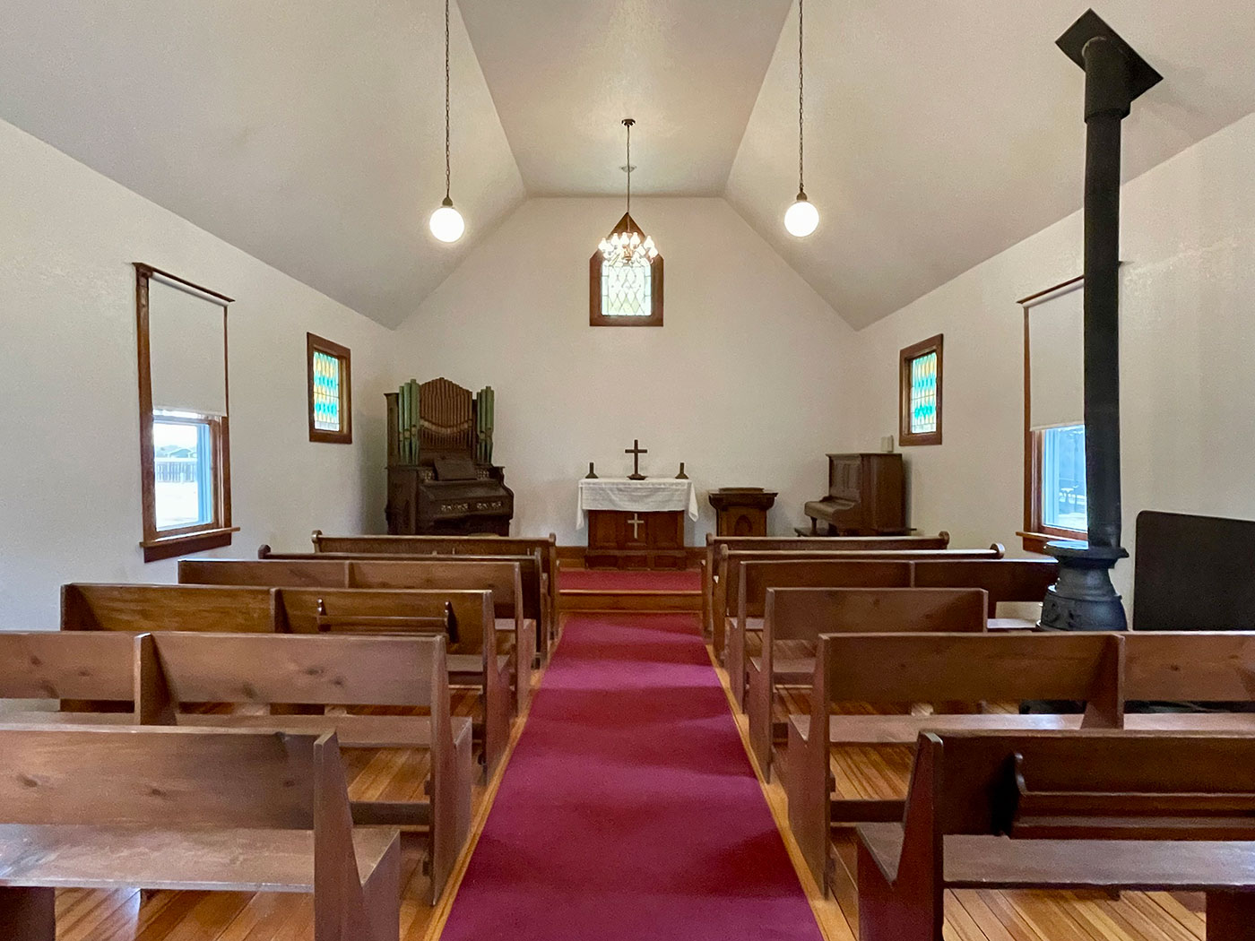 Church interior with vaulted ceilings, looking down the pews toward the pulpit