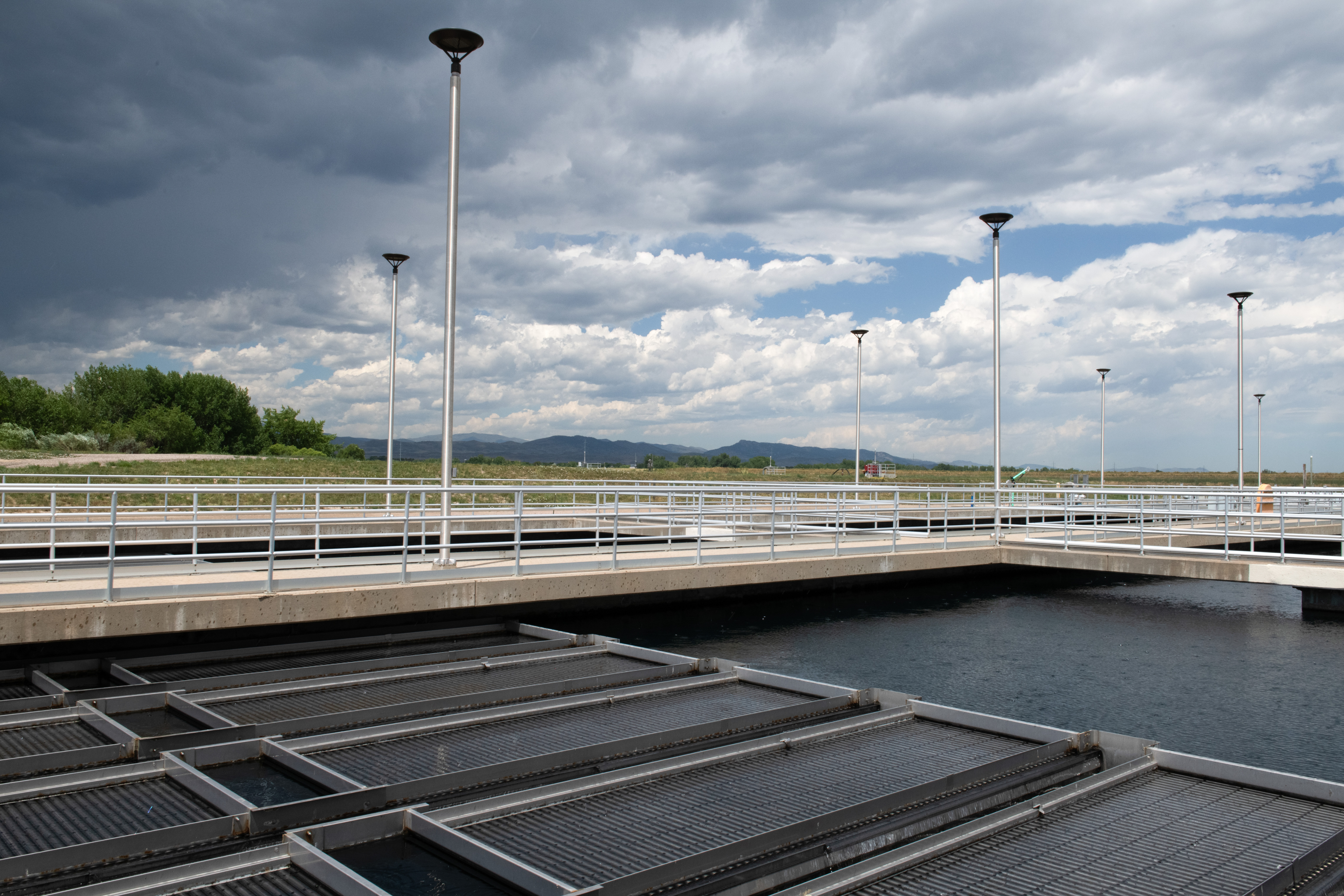 Photograph of Boyd Lake Water Treatment Plant Sedimentation Basin and Plate Settlers outside with view of mountains in the background.