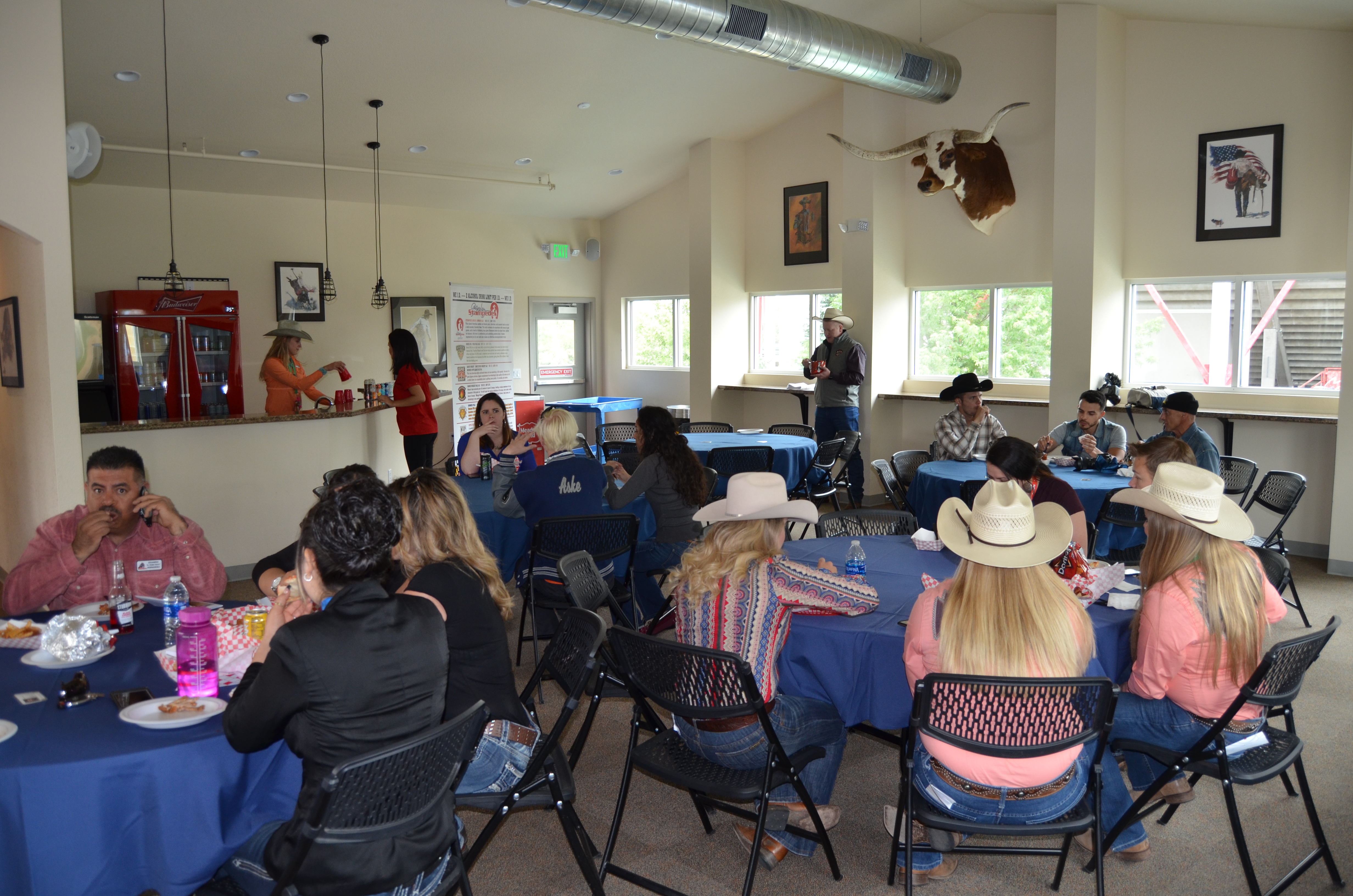People sitting at tables at a meeting of Buckle Club at Island Grove Regional Park