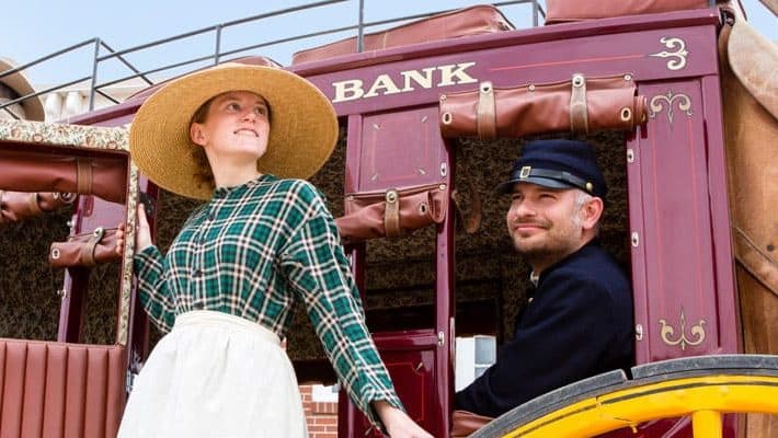 A classic scene featuring actors in prairie costumes illustrating historical life at Centennial Village Museum in Greeley, Colorado.