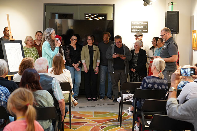Betsy Kellums, City of Greeley Planner, presents the Historic Preservation awards at an indoor event