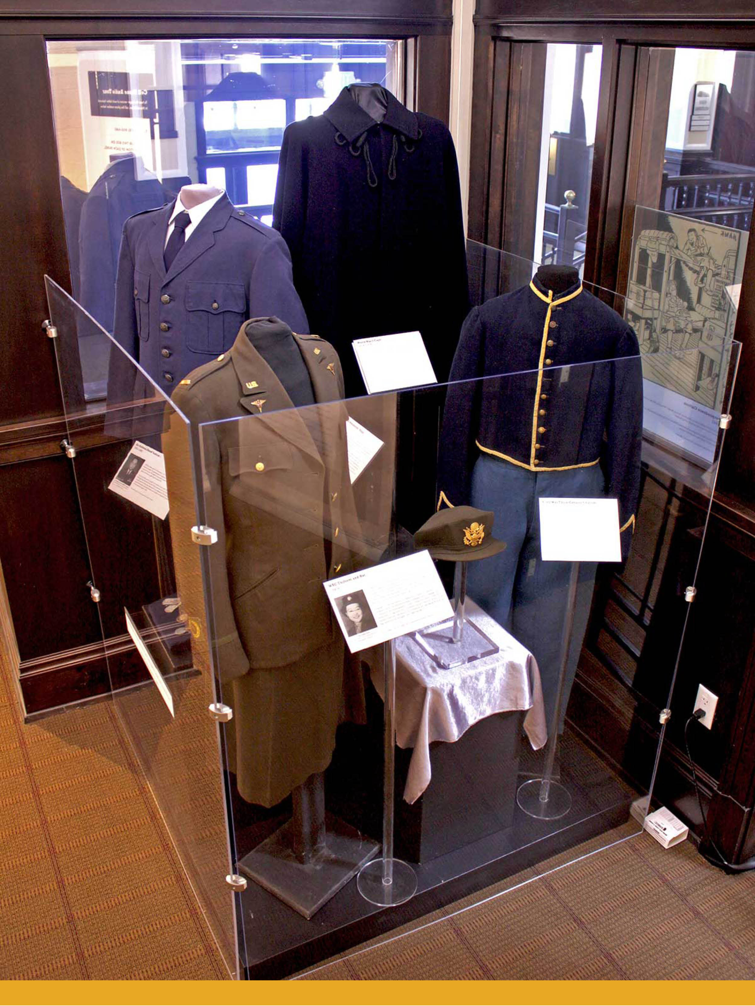 A display of four mannequins wearing military uniforms from different wars