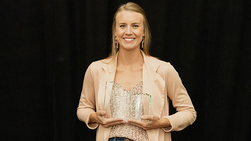 Whitney Dyer receiving recognition for her achievements with an Outstanding New Professional Award.