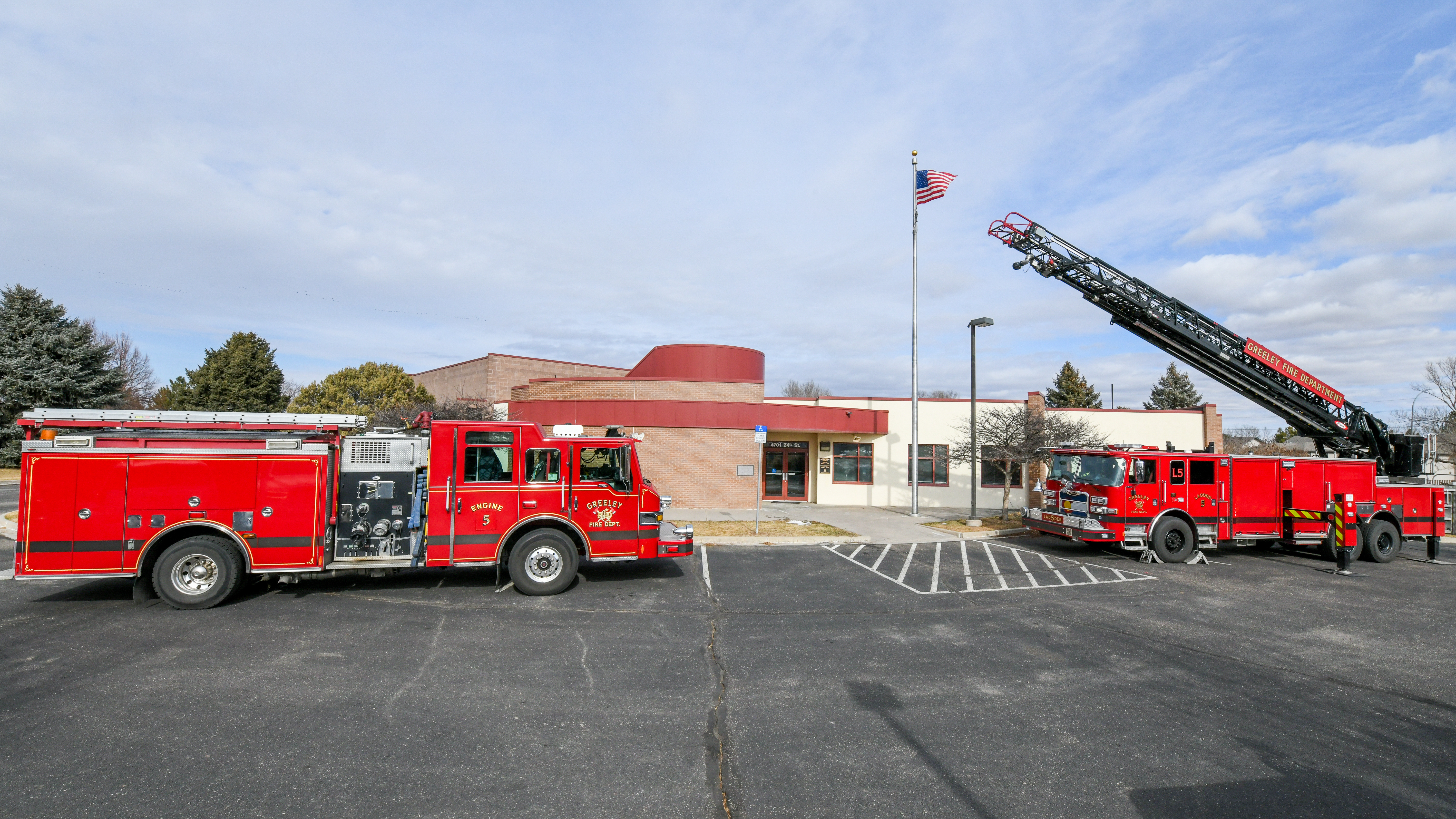 Two firetrucks displayed outside of Greeley Fire Station 5.