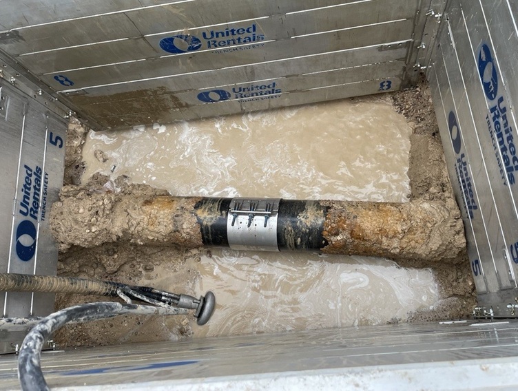 Picture of a water main with repair band in place. 