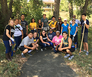 A group of volunteers gathered outdoors, engaged in a community activity, and promoting togetherness.