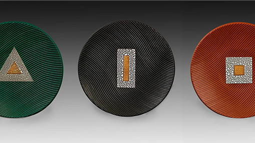 Ceramic works featuring geometric designs and textured surfaces displayed in varied colors.