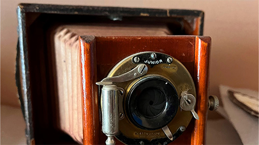 A close-up view of a vintage camera showcasing its intricate design and craftsmanship.