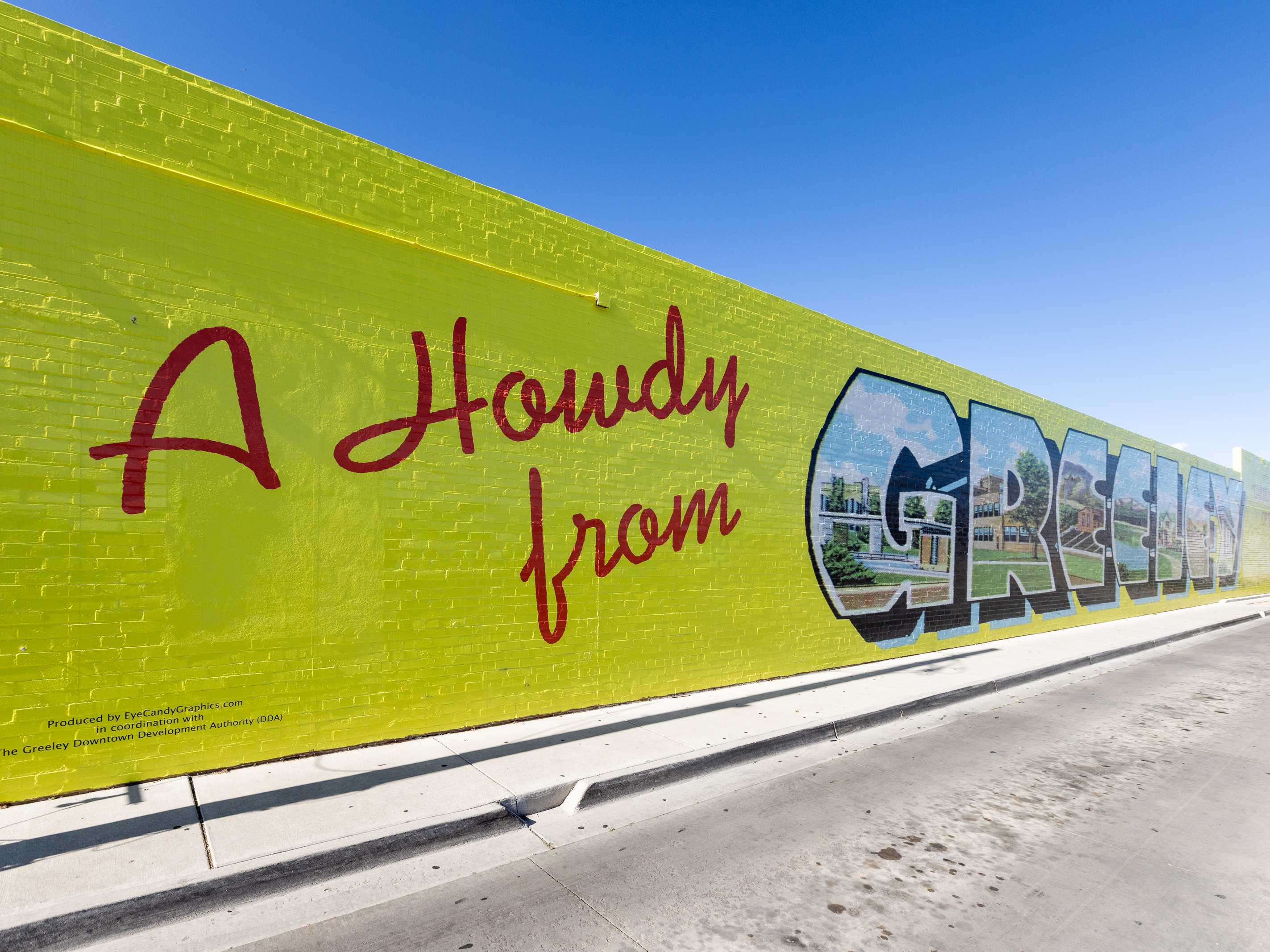 Painted wall mural that reads, A howdy from Greeley