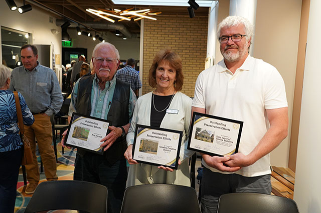 2026 winners pose for a group photo with their awards at the Historic Preservation Month event. 