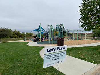 A vibrant playground surrounded by greenery featuring modern play structures for children to enjoy.