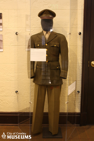 Mannequin displayed behind plexiglas wearing an Army Air Force Uniform and hat