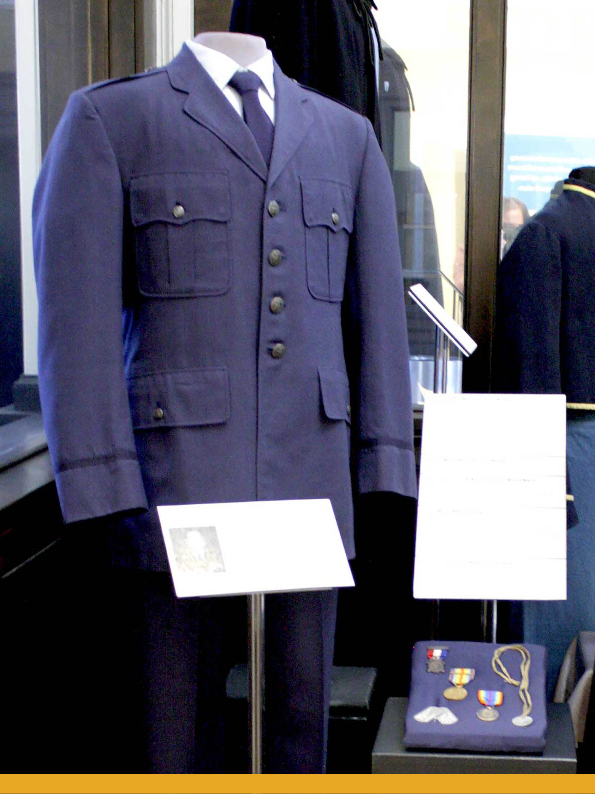 Image of a mannequin wearing a dark blue Air Force uniform.