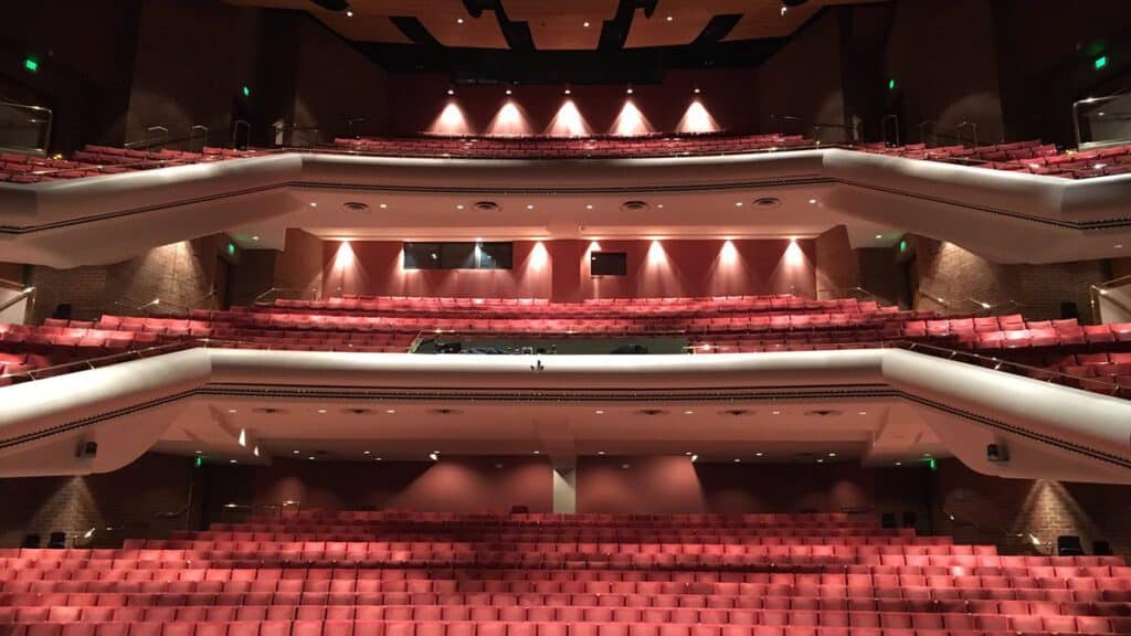 Interior view showcasing empty red velvet seats and the elegant design of Union Colony Civic Center.