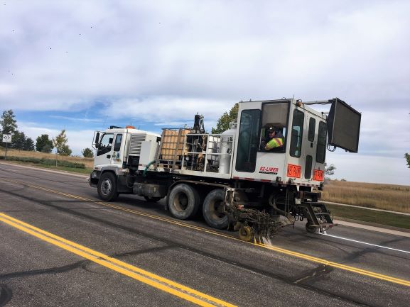 A truck used for painting road stripes, ensuring clear lane markings and traffic safety.