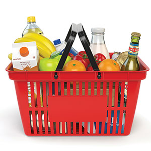 A red basket filled with various groceries including fruits, beverages, and packaged goods.